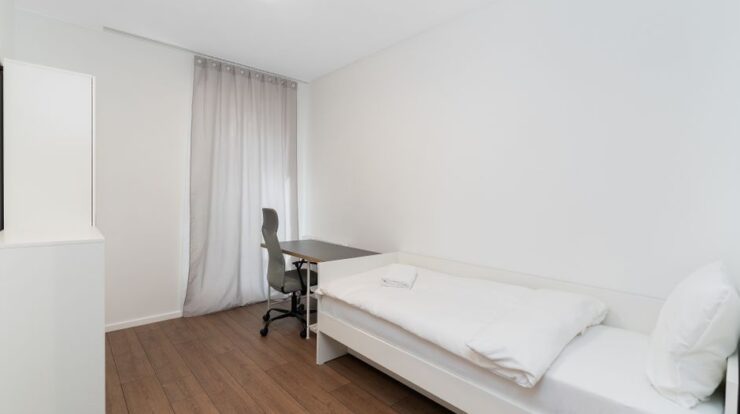 Bright minimalist bedroom with a single bed and desk, ideal for modern living. - Photo by Mateusz Pielech on Pexels